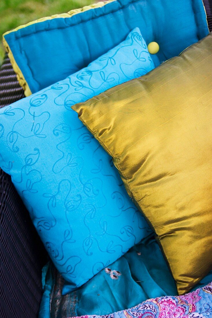 One gold cushion and one blue patterned cushion