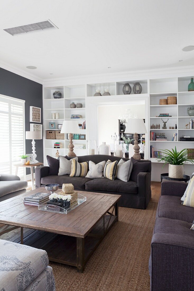 Black sofa set around wooden coffee … – License image – 11295086 ❘ Image  Professionals