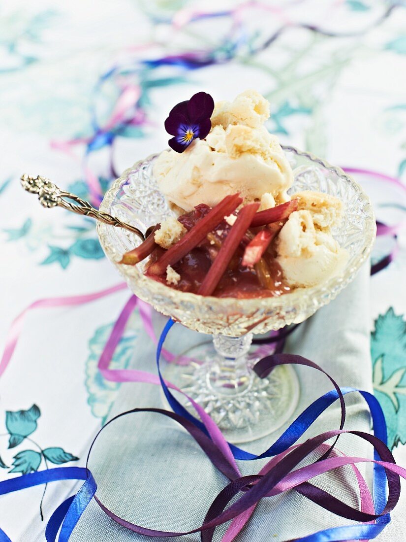 Vanilla ice cream with rhubarb sauce and violets