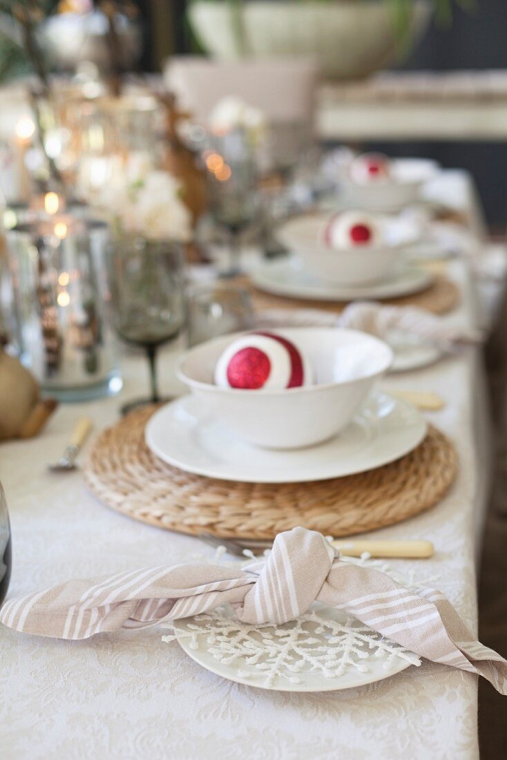 Festively set table with Christmas baubles in bowls