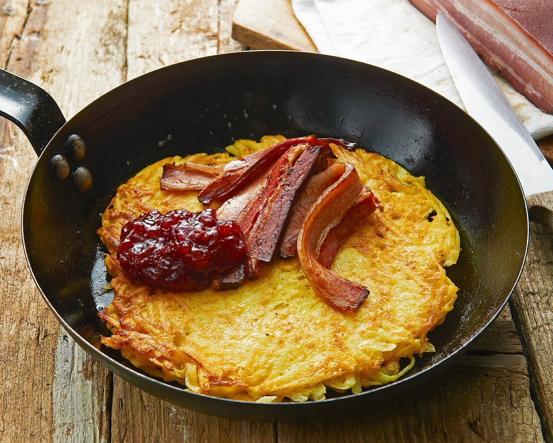 Potato omelette with cheese, bacon and cranberry sauce