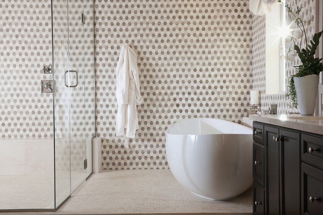 Contemporary bathroom with bathtub and glass shower; Irvine; California; USA