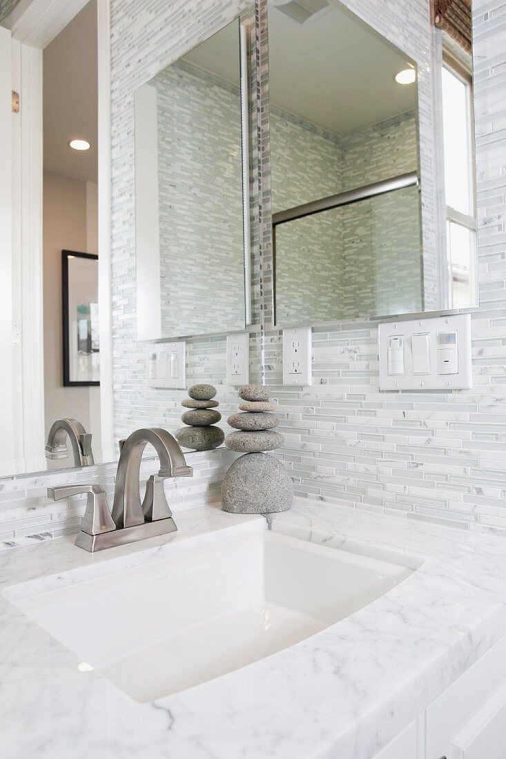 Contemporary bathroom with marble washbasin and mirror; Irvine; California; USA