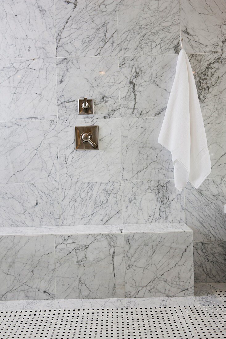 White towel and tap on marble wall in bathroom; Irvine; California; USA