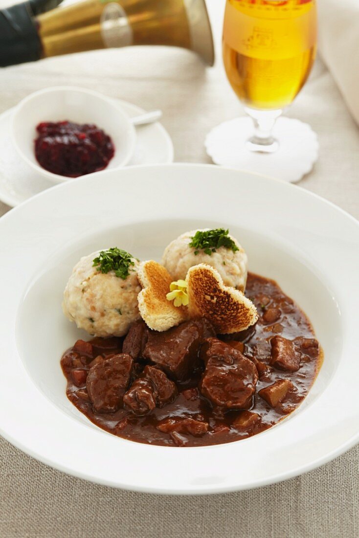 Young venison ragout with bread dumplings and cranberries