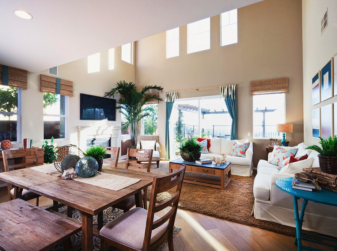 Wooden dining table and living room in open-plan home; San Marcos; California; USA