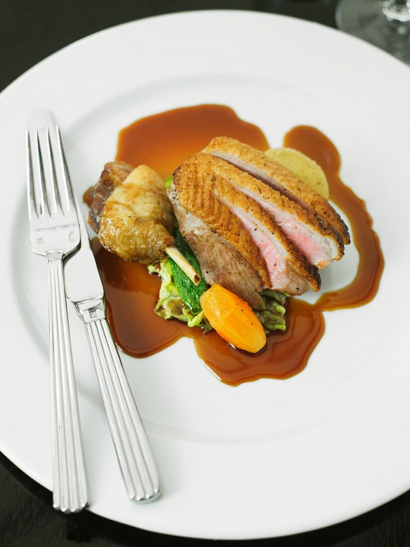 Roast duck with gravy and vegetables