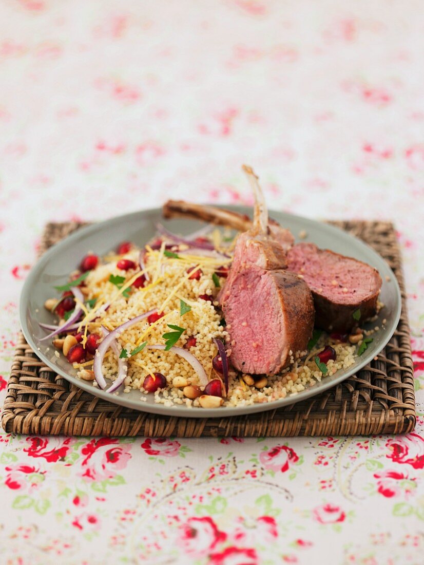 Lamb chops on a bed of couscous with pomegranate seeds and pine nuts