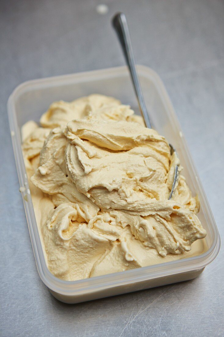 Homemade toffee ice cream in a plastic container