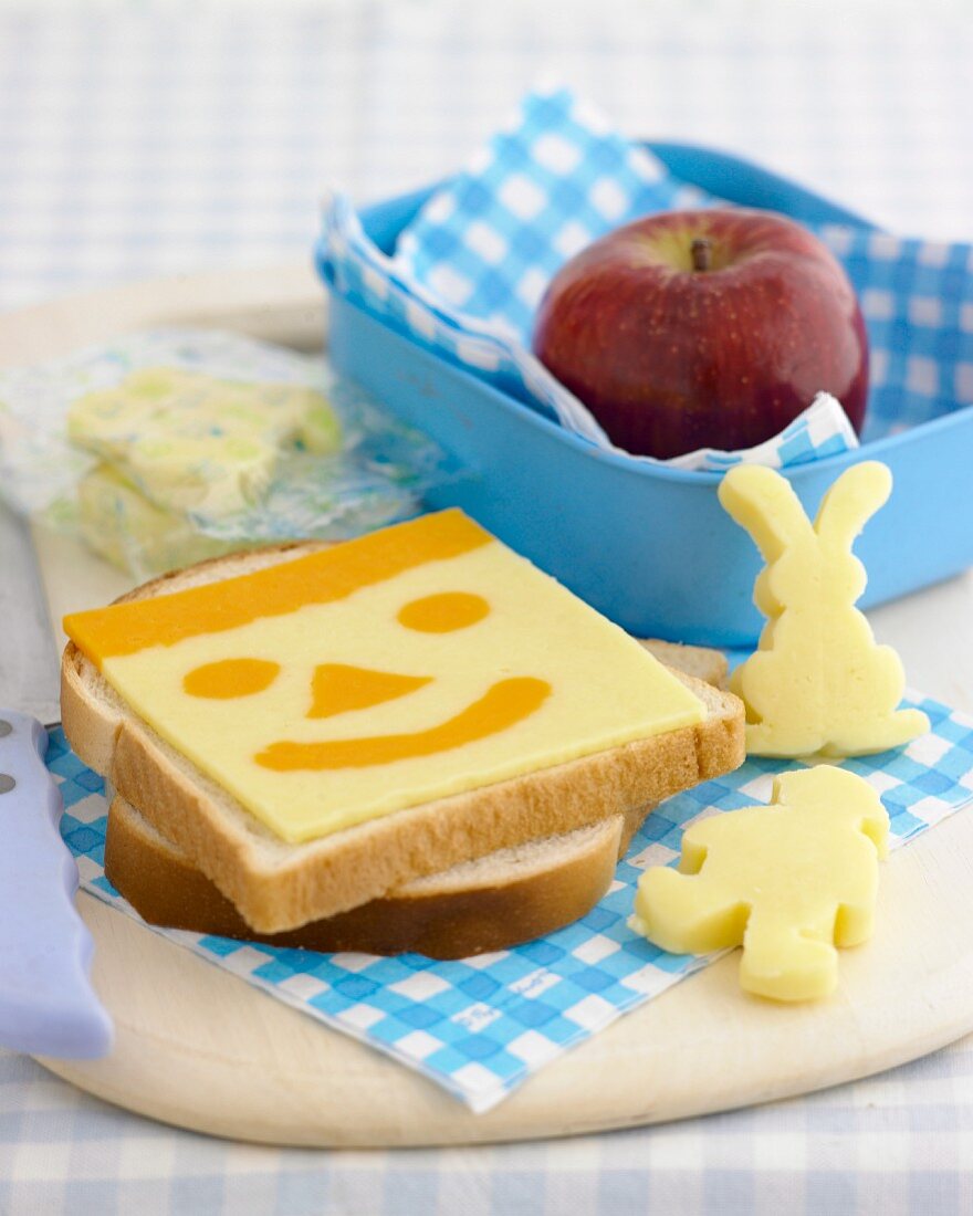 A snack for children with a funny cheese face