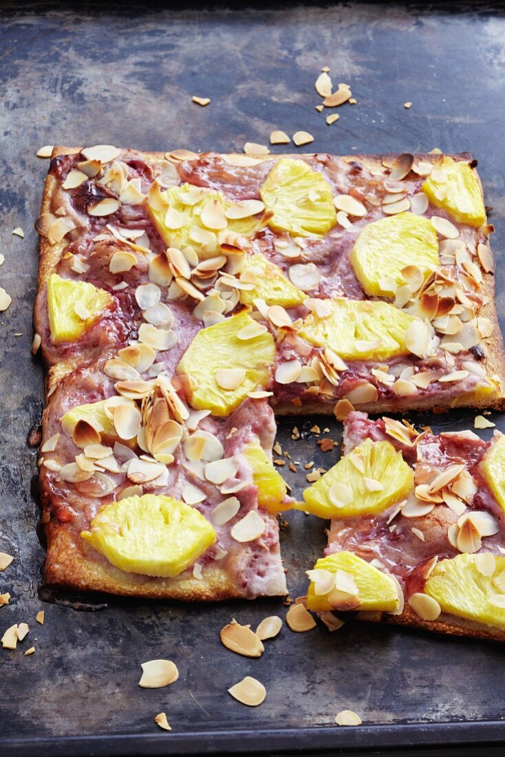 A sweet pizza topped with raspberries and pineapple