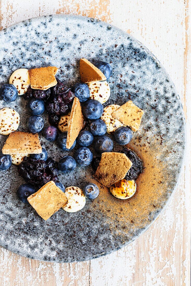 Blueberries with white chocolate cream and liquorice meringue