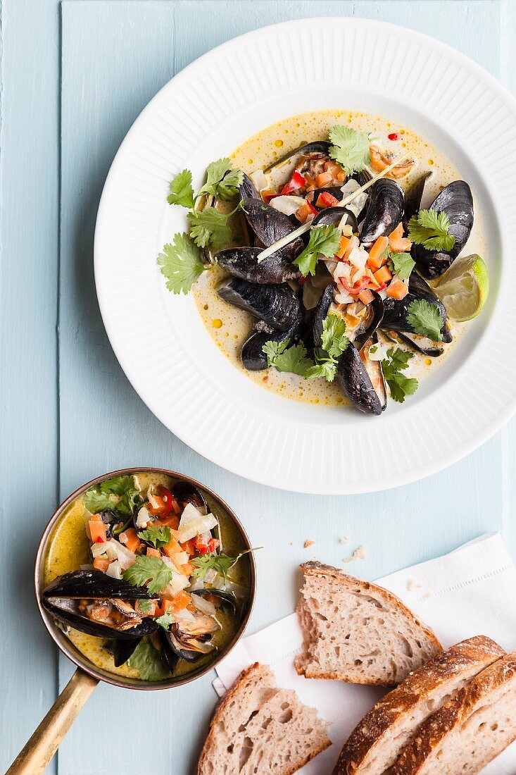 Steamed mussels with beer, coconut, vegetables, coriander and limes