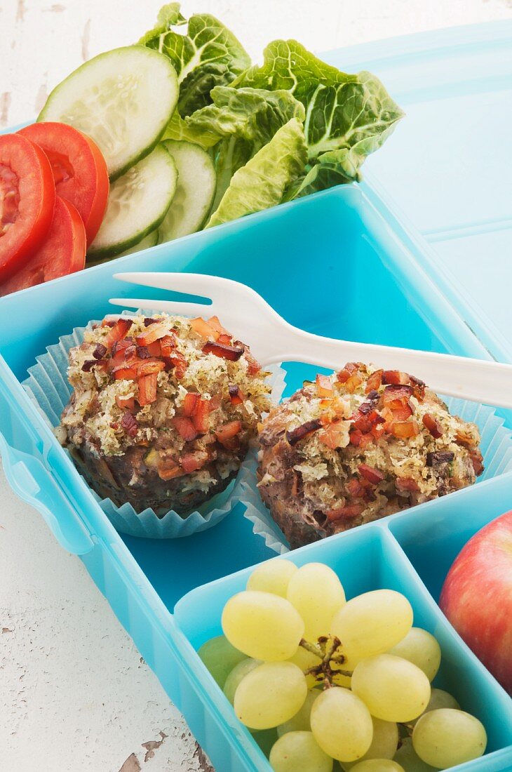 Meatballs, grapes and a salad in a lunchbox