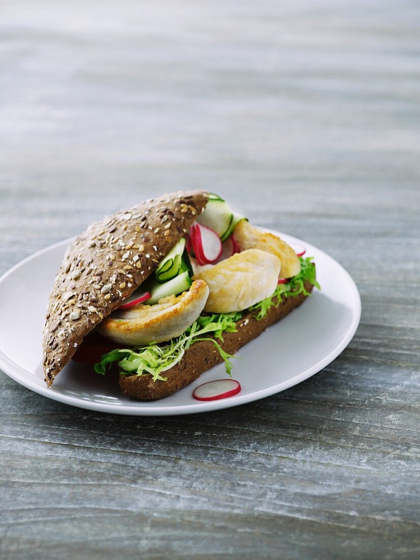 Chicken, radishes and cucumber on a wholemeal roll