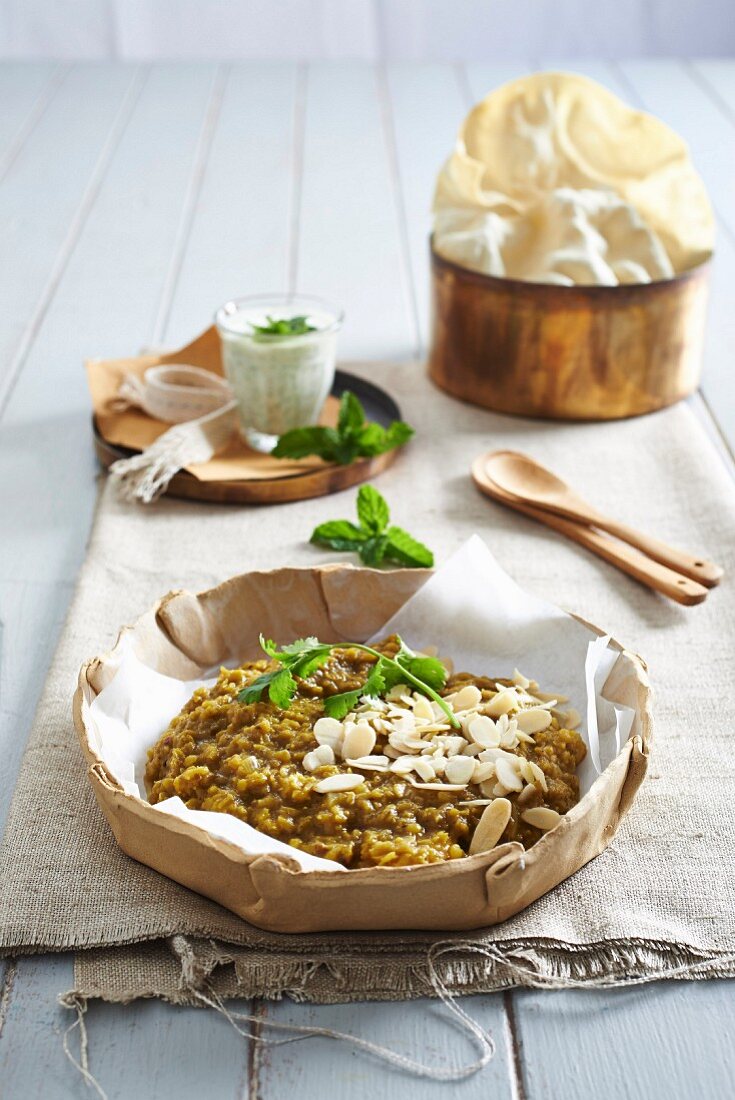 Masur Dal with poppadoms and raita