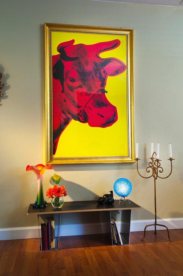 Vases on console table by candlestick holder below painting on wall; West Palm Beach; USA