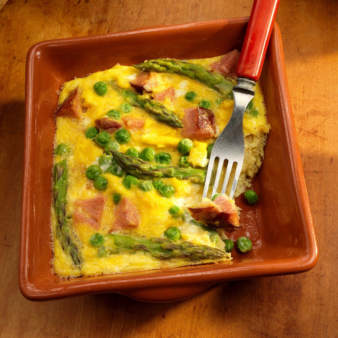 Basque eggs with ham, peas and asparagus with a bite take out