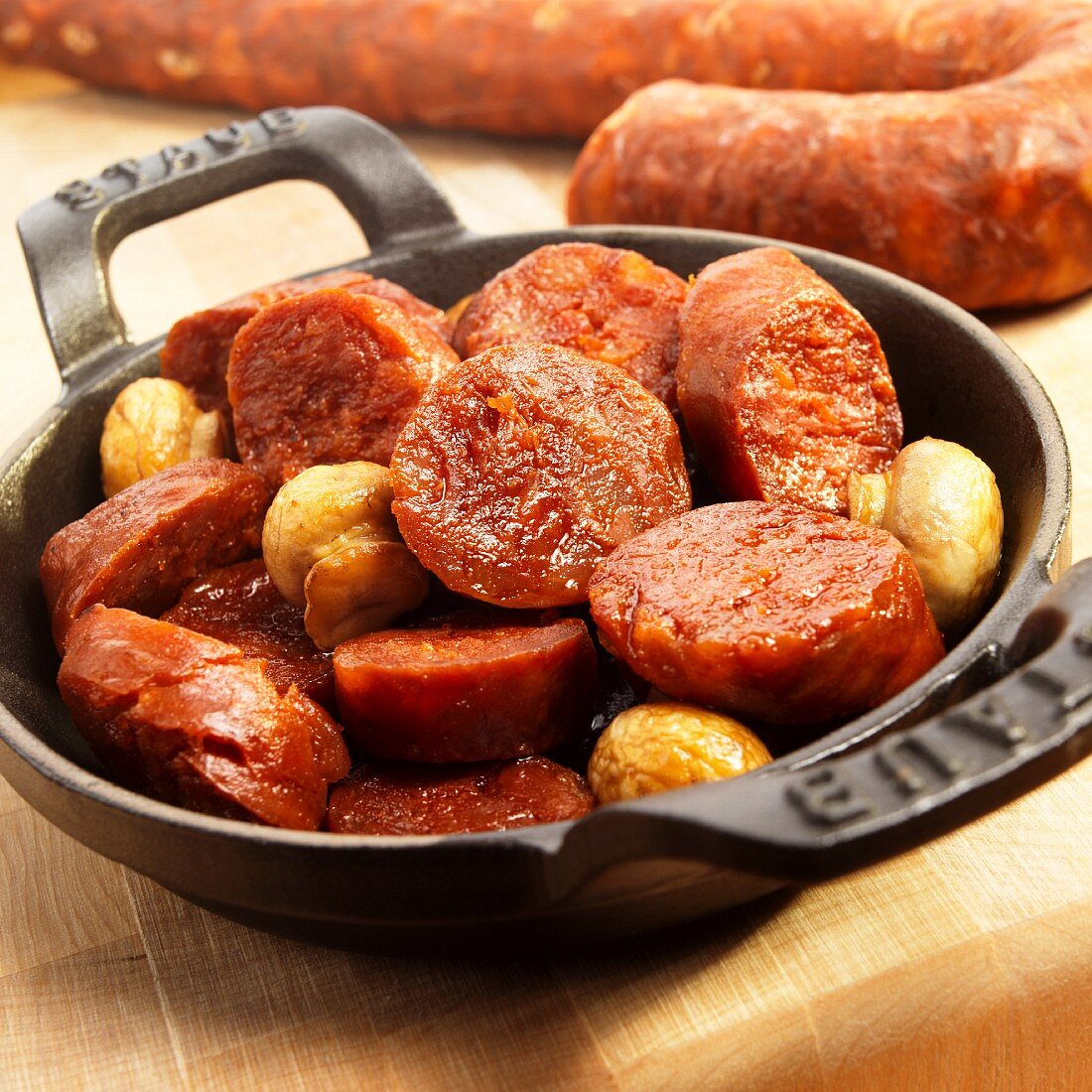 Chorizo and mushrooms in a black iron pan (Spain)