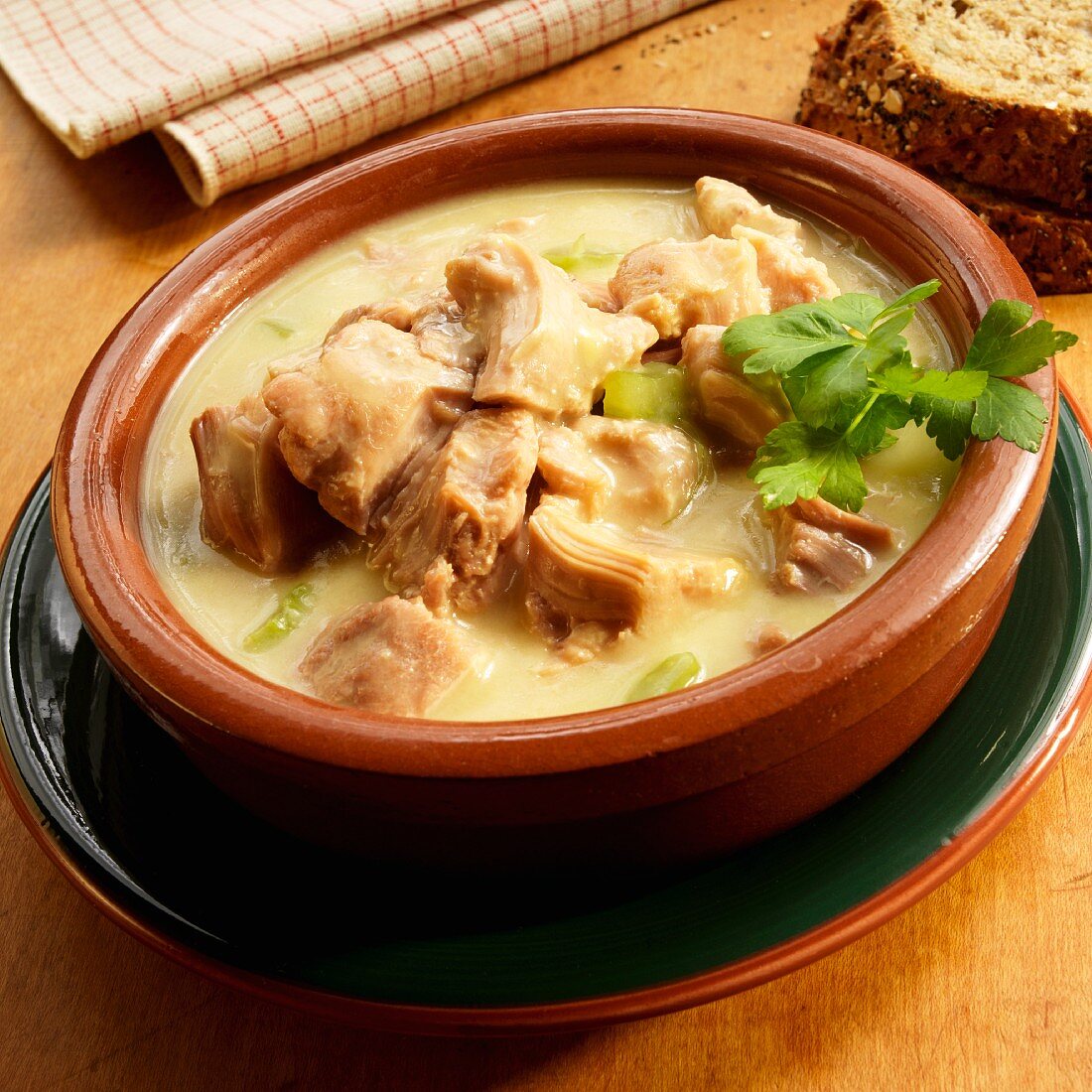 Cream of turkey soup in earthenware bowl with parsley
