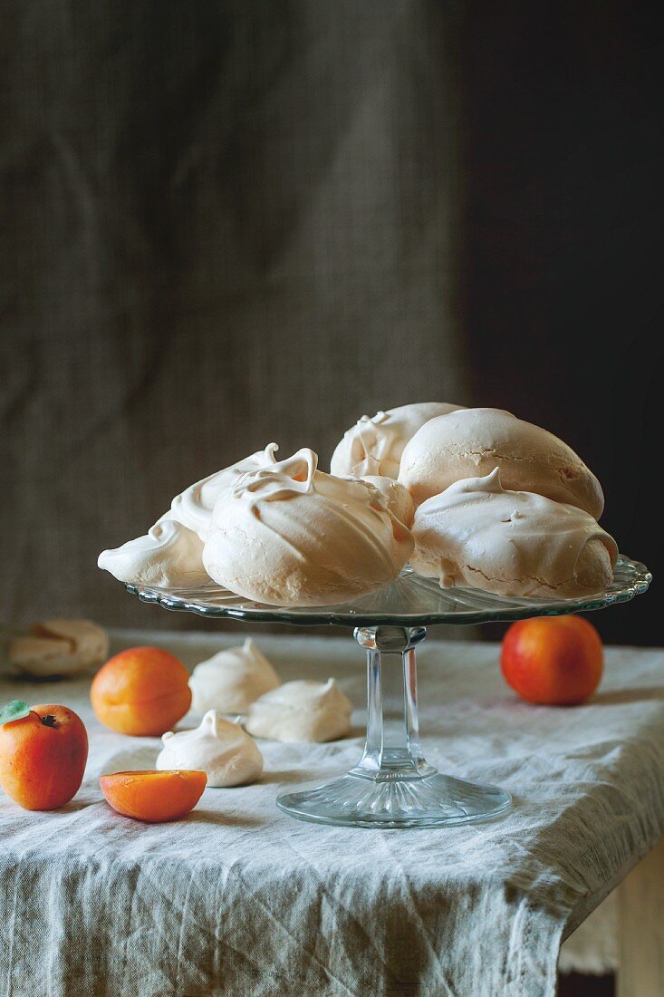 Meringues and apricots on a table