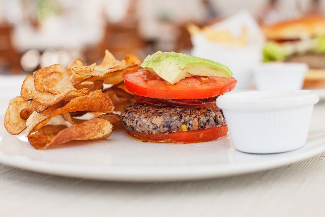 A quinoa burger with tomato and avocado in a cafe in South Beach, Miami, Florida