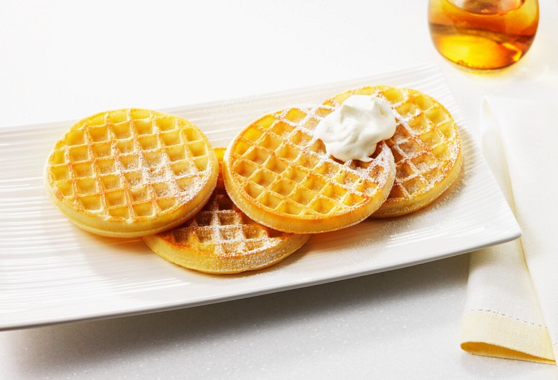 Waffles with icing sugar and cream
