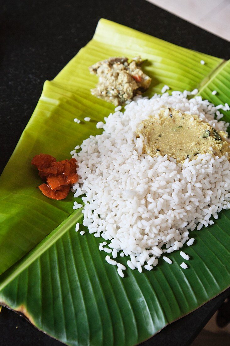 Reis mit Dal und Chutney auf Bananenblatt (Indien)