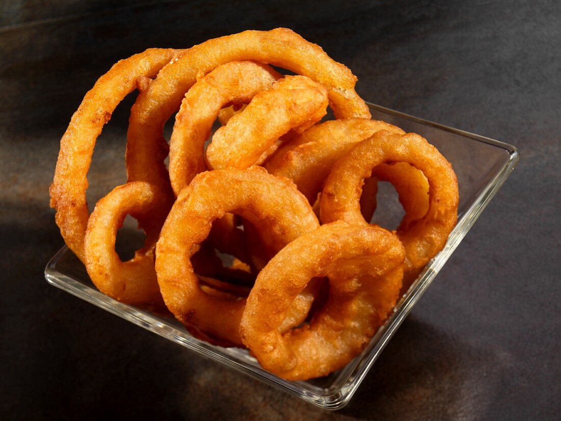 Fried onion rings in glass bowl