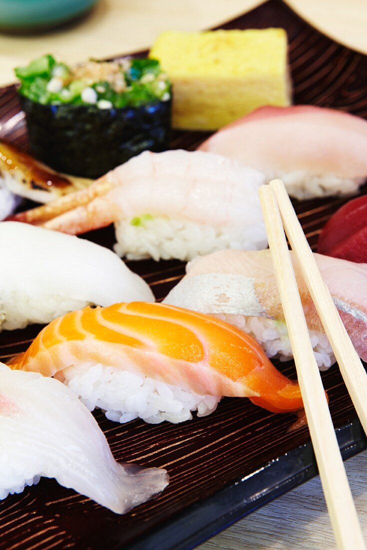 A sushi platter with chopsticks