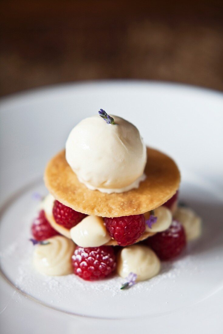 A layered dessert with shortcrust biscuits, raspberries, lavender and ice cream