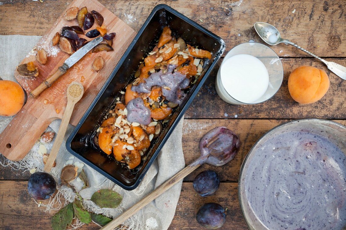 Unbaked plum and apricot cake in a loaf tin