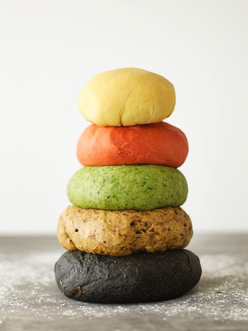 A stack of various coloured pasta dough