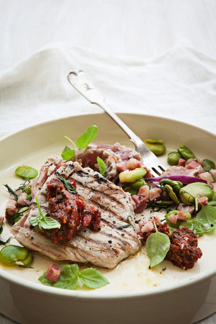 Flash fried tuna fish steak with broad beans and tomato tapenade