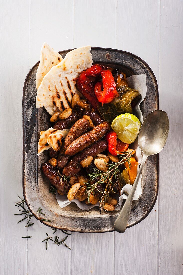 Sausages with roasted vegetables and unleavened bread