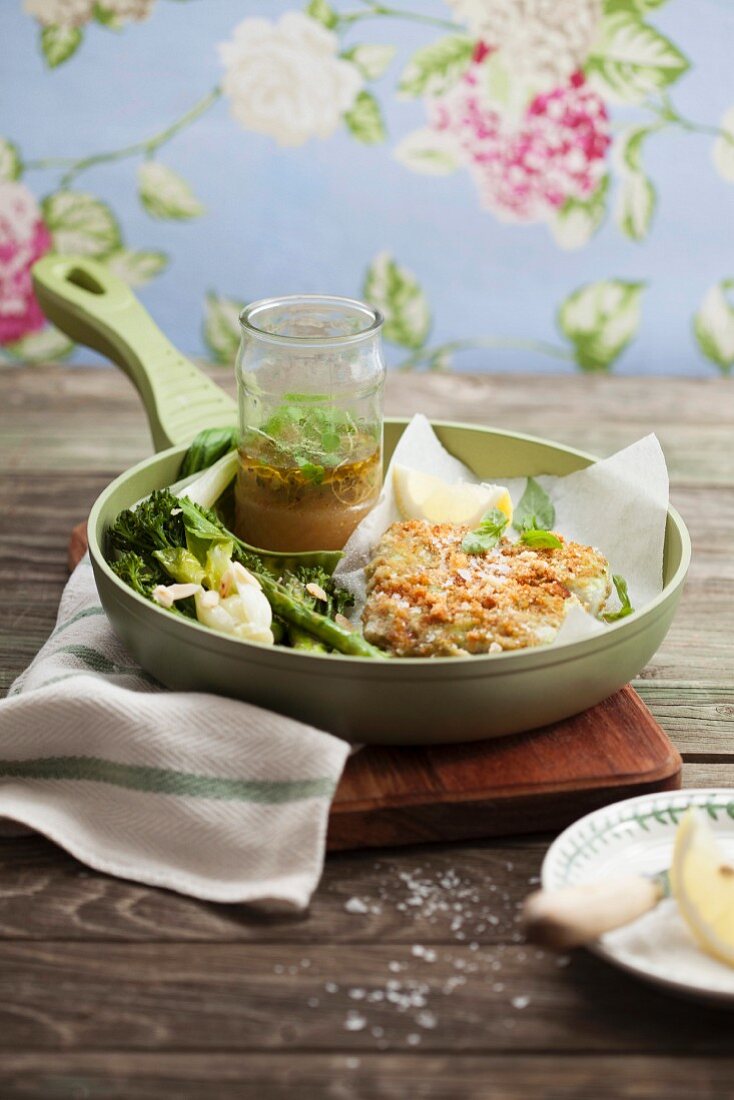 Hake with a crust and green vegetables