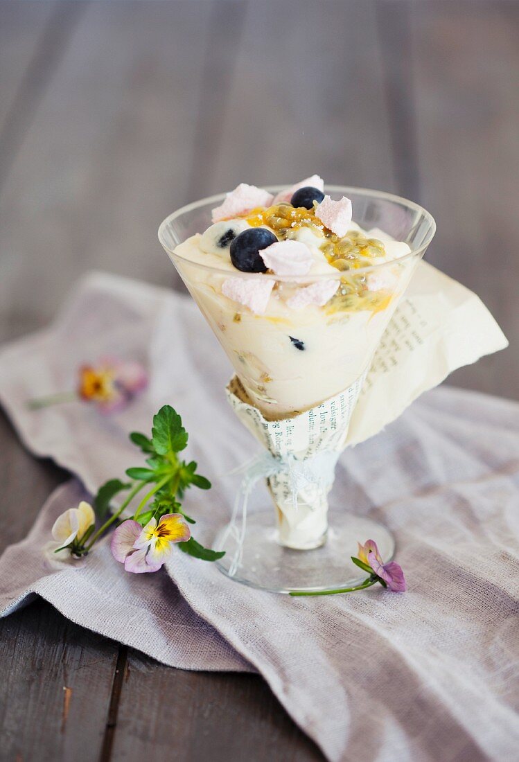 Vanilla cream with blueberries and passion fruit sauce