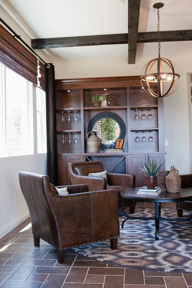 Arm chairs and coffee table in living room; Valencia; California; USA