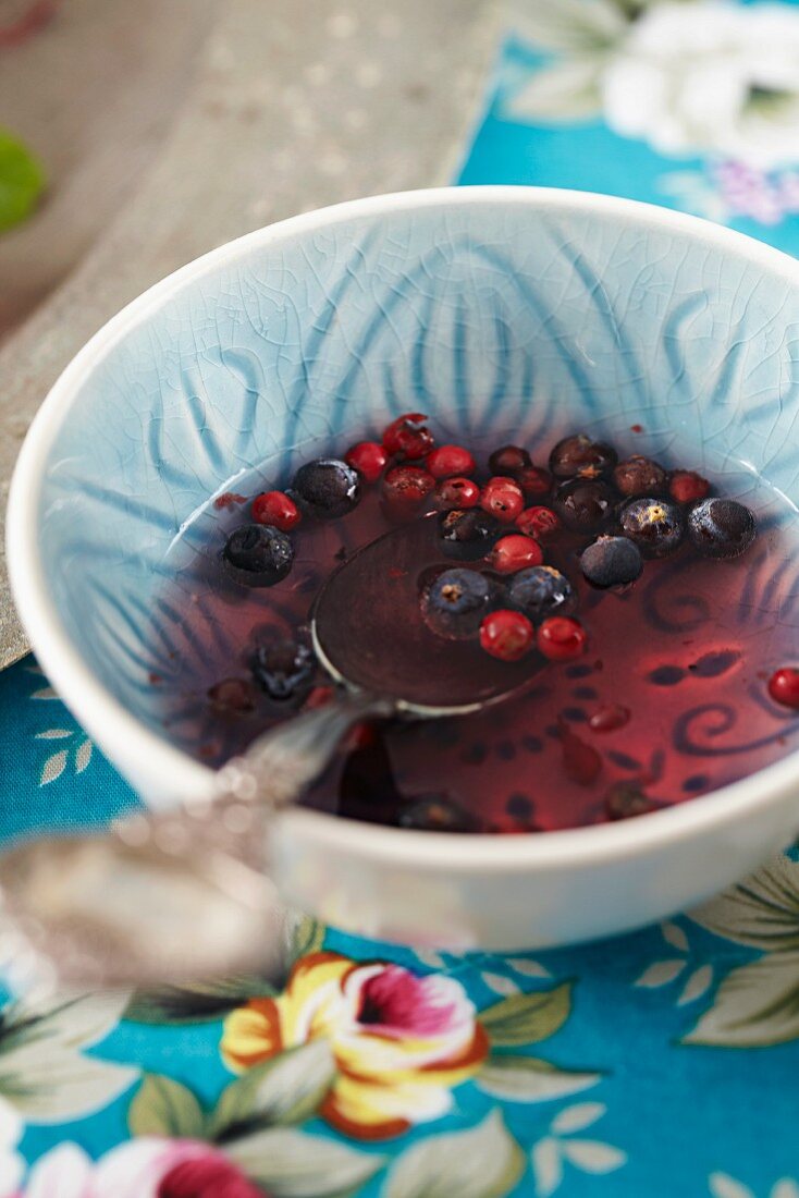 A berry dressing in a small ceramic bowl