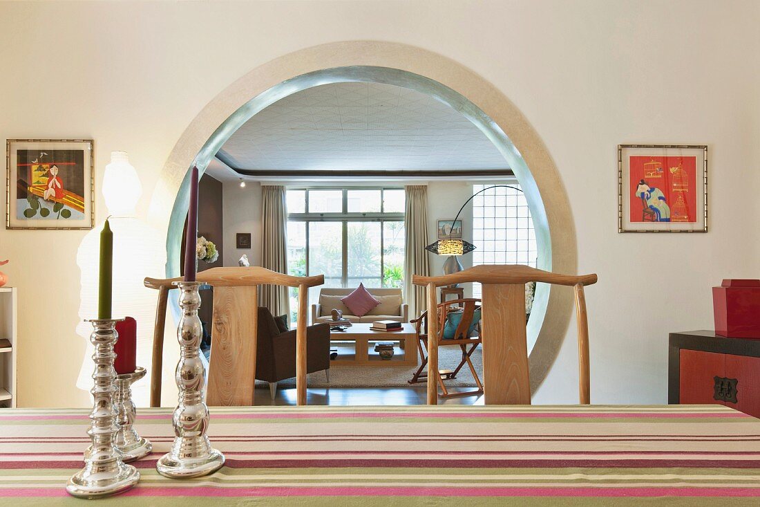 Detail of candles on dining table with living area in background