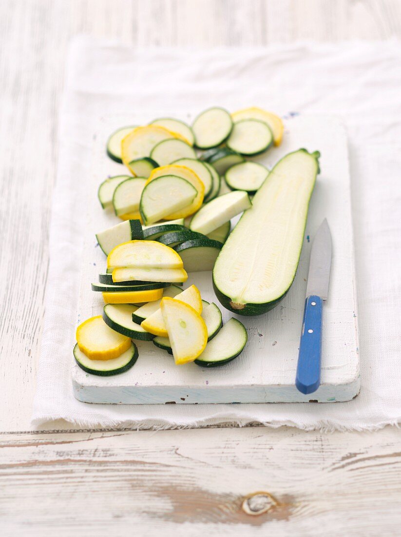 Green and yellow courgettes, halved and sliced