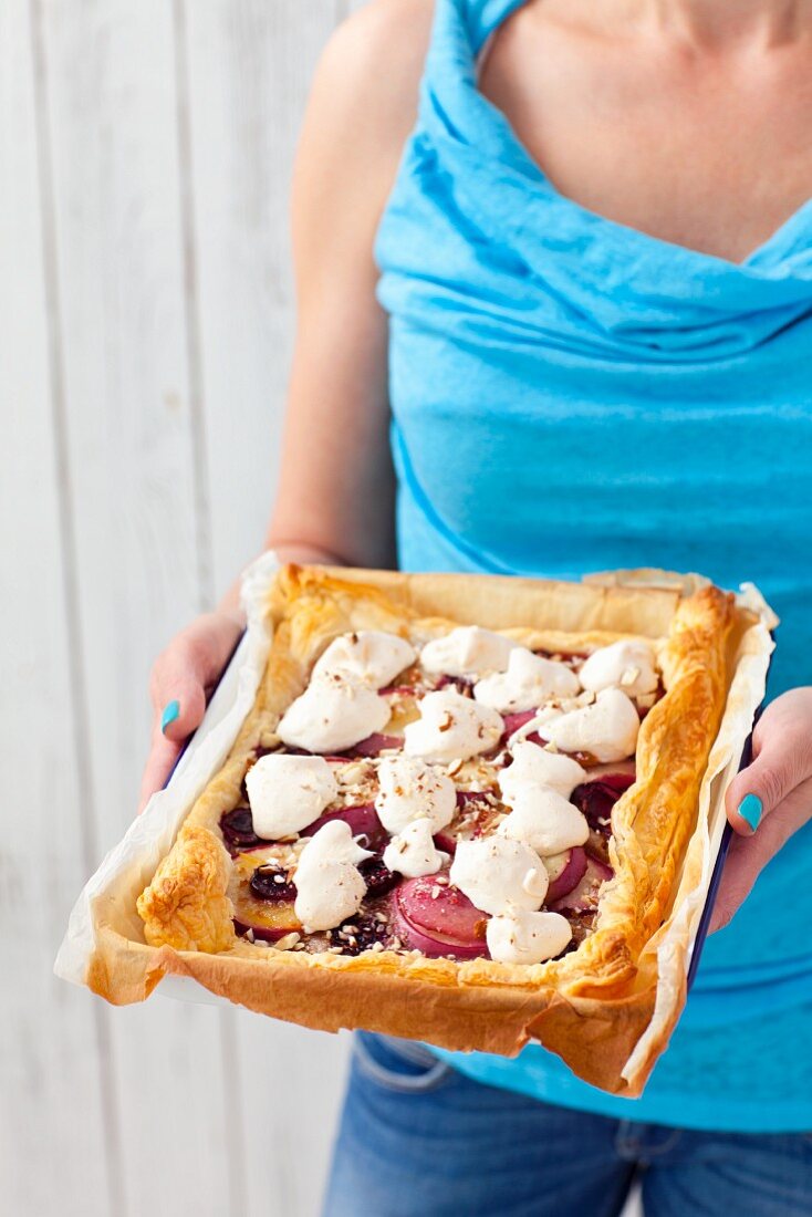 A puff pastry tart with almond cream, nectarines, cherries and meringue