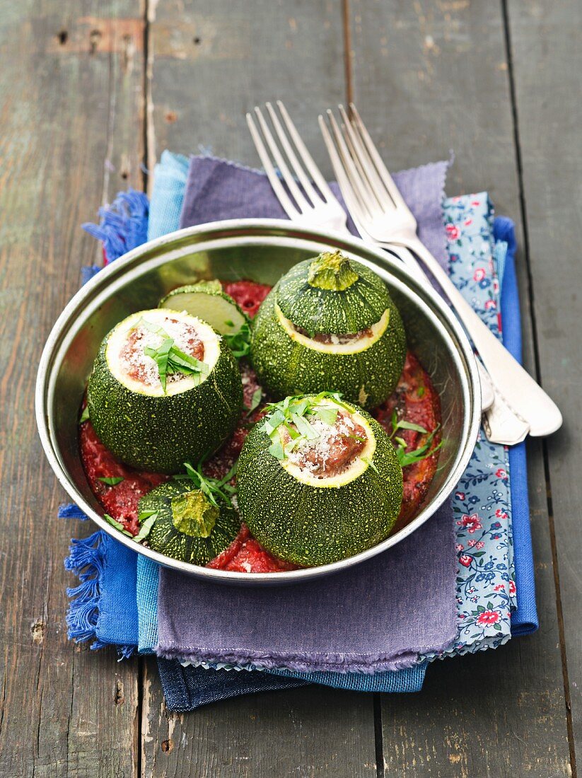 Round courgettes with minced meat filling in tomato sauce