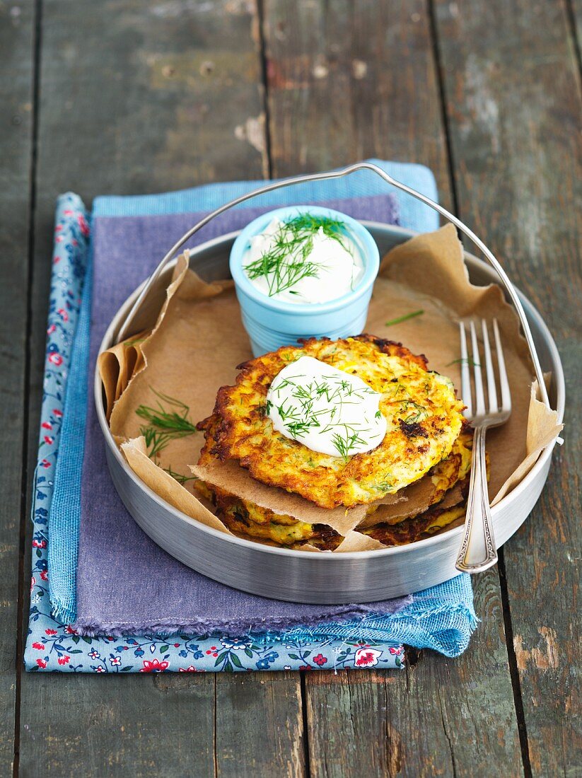 Yellow courgette fritters with sour cream and dill
