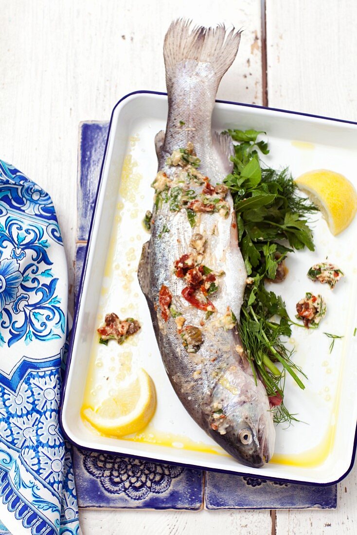 Fresh trout with herbs, lemons and dried tomatoes