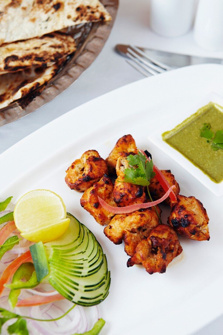 Indian chicken skewers with salad and unleavened bread