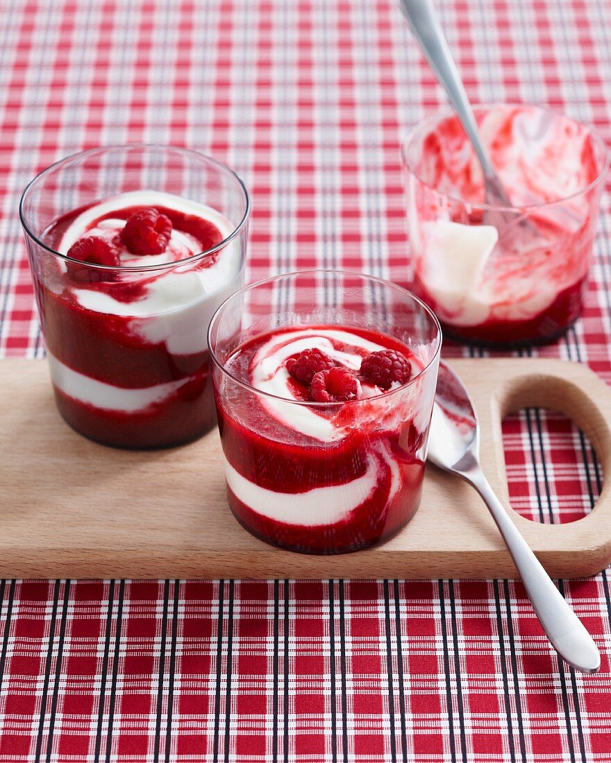 Raspberry yogurt swirl desserts garnished with fresh raspberries