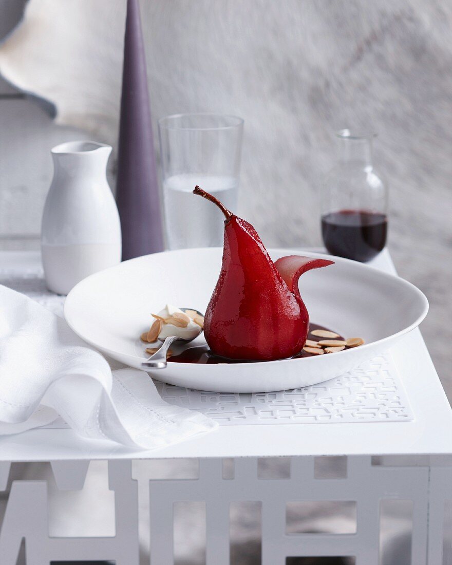 A red wine pear with flaked almonds