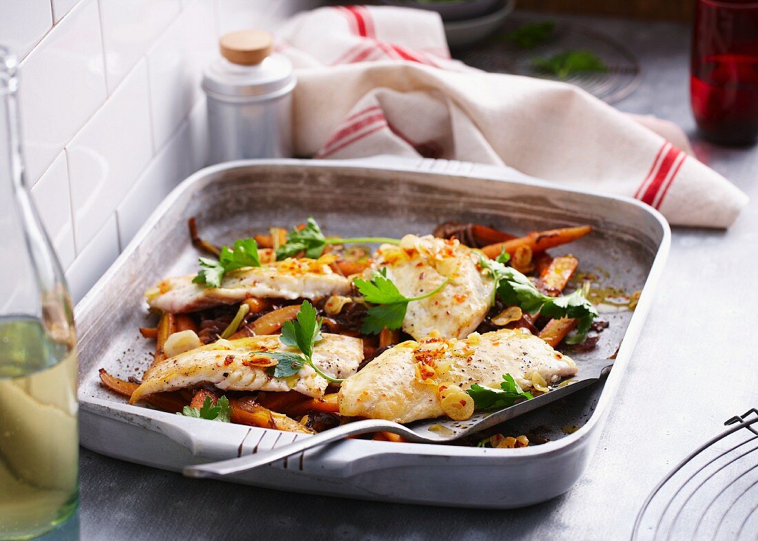 Roast snapper in a baking dish garnished with parsley
