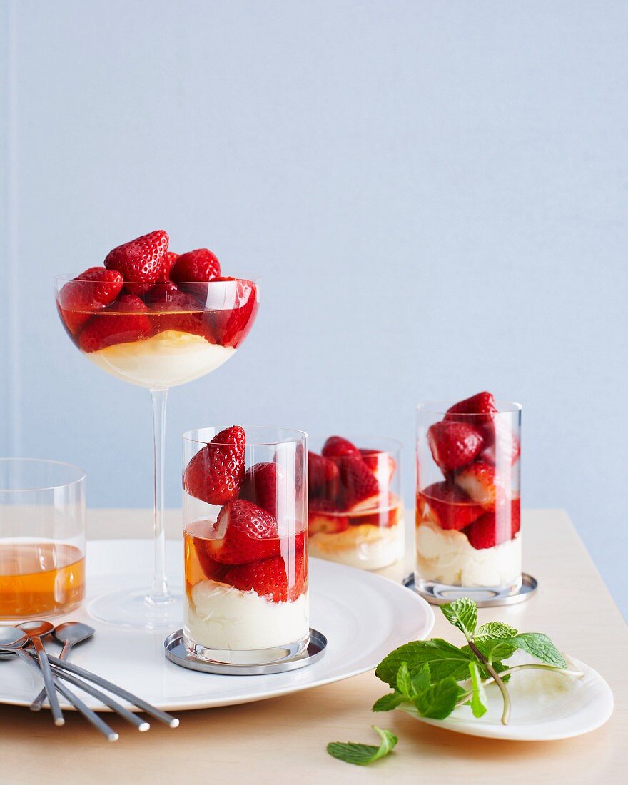 Champagne-poached strawberries with vanilla cream in glasses